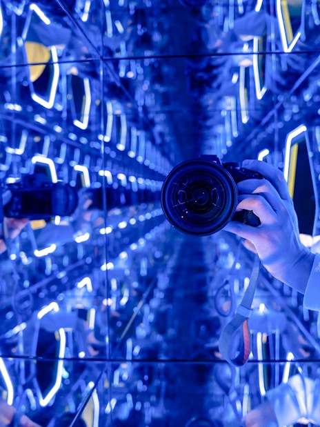 Mirrored room with neon lights at World Of Illusions exhibit.