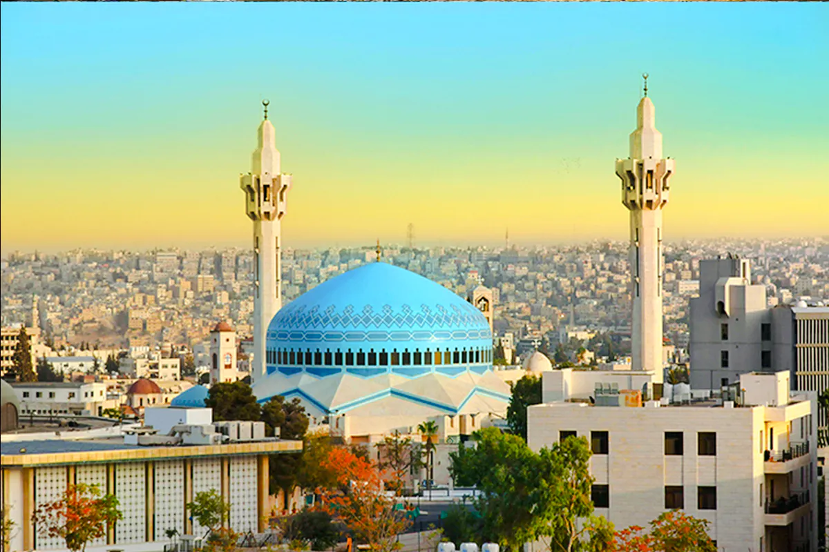 Blue-domed King Abdullah I Mosque with minarets in Amman cityscape, Amman City Sightseeing Tour.