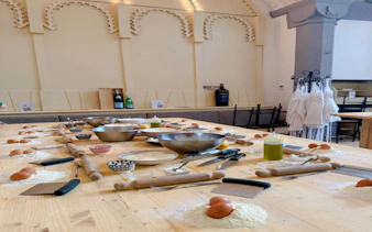 Pasta and dessert making class setup with ingredients and tools in Florence.