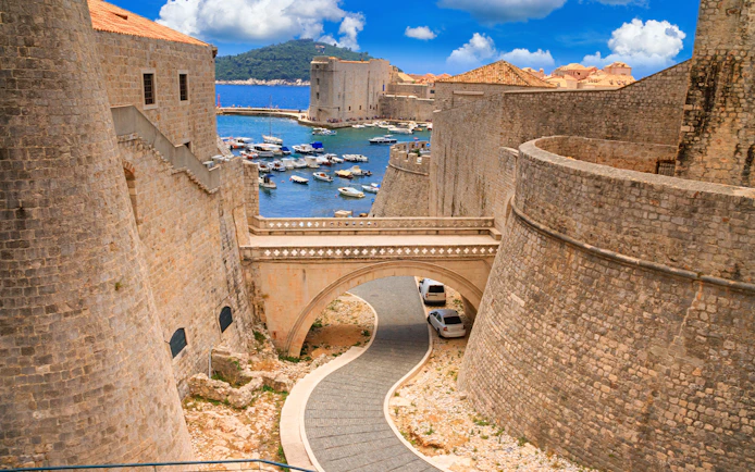 Ancient stone walls and bridge in Dubrovnik, Croatia, overlooking the Adriatic Sea.