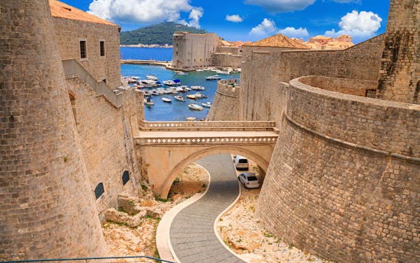 Ancient stone walls and bridge in Dubrovnik, Croatia, overlooking the Adriatic Sea.