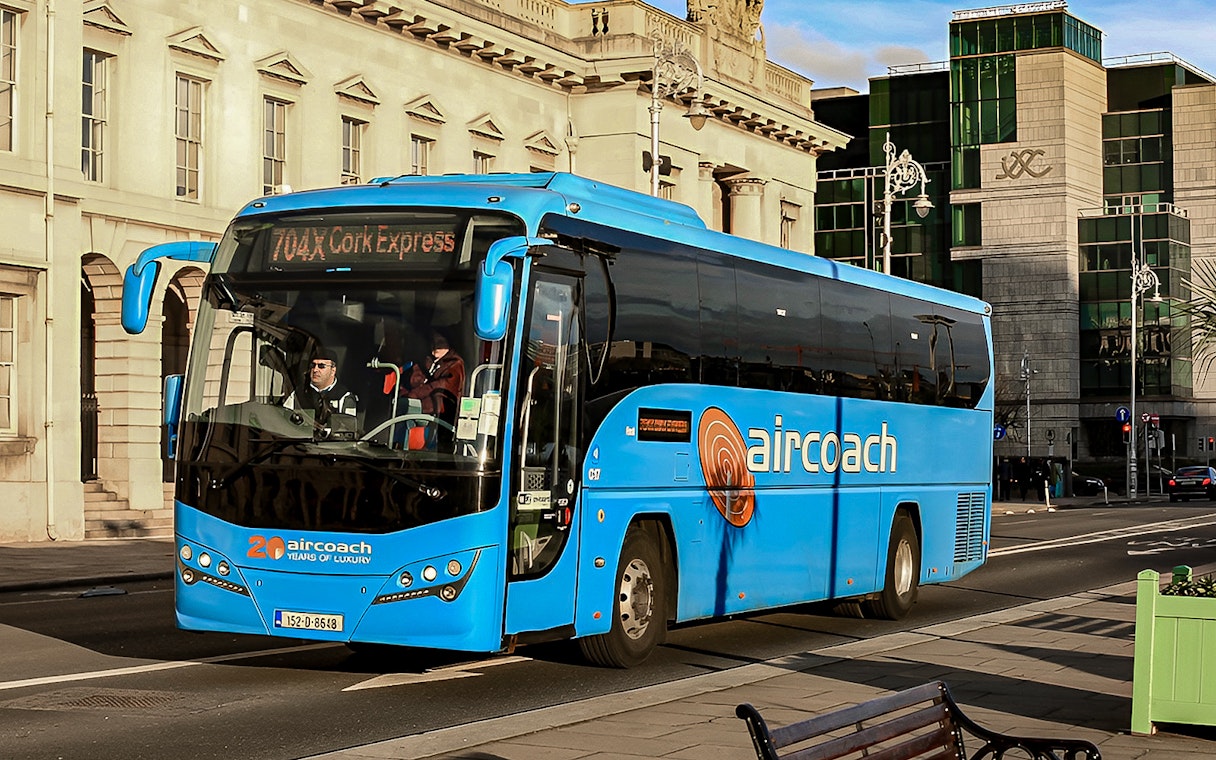 Dublin Aircoach bus on city street for airport transfers.
