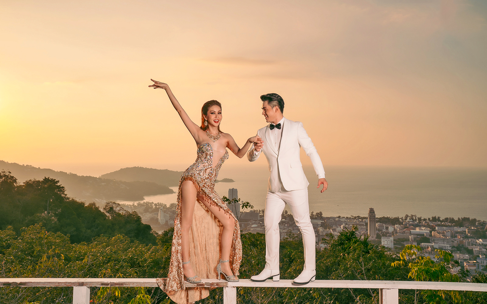 Performers at Simon Cabaret Show with Phuket cityscape in the background.