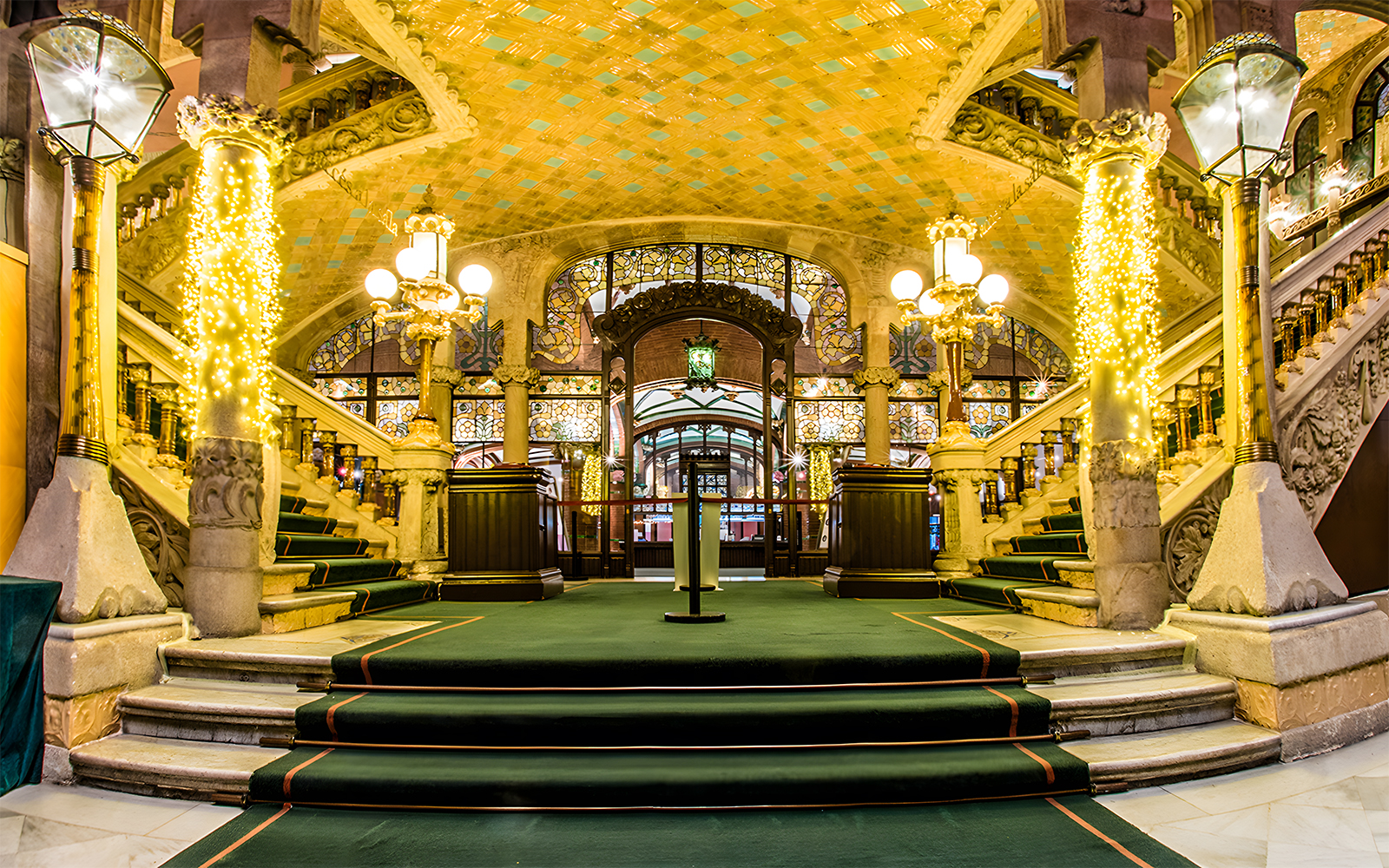 Palau de la Música Catalana interior with ornate staircase and stained glass.