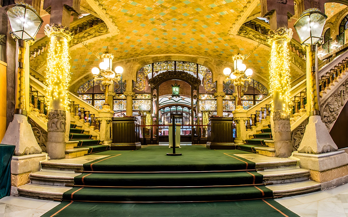 Palau de la Música Catalana interior with ornate staircase and stained glass.