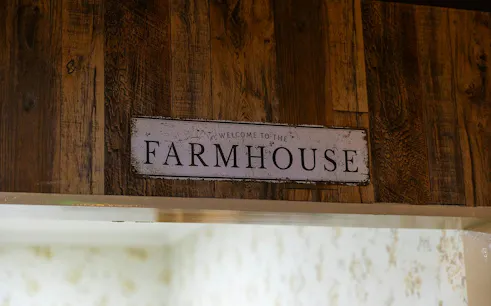 Farmhouse sign at escape room entrance, part of Premium 1-Hour Animal Tour, Brisbane.
