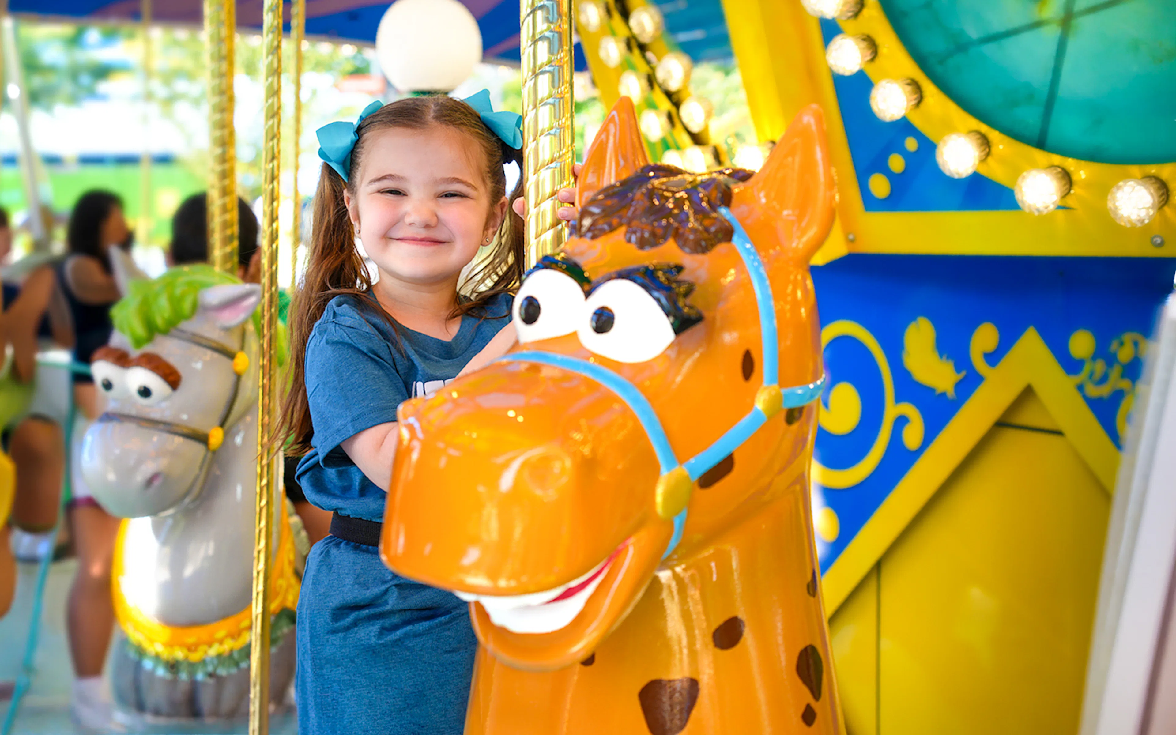 Child enjoying carousel ride at Sesame Place Philadelphia.
