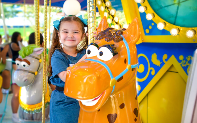 Child enjoying carousel ride at Sesame Place Philadelphia.