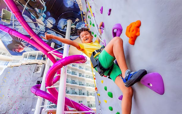 Child climbing rock wall on Anthem of the Seas cruise ship.