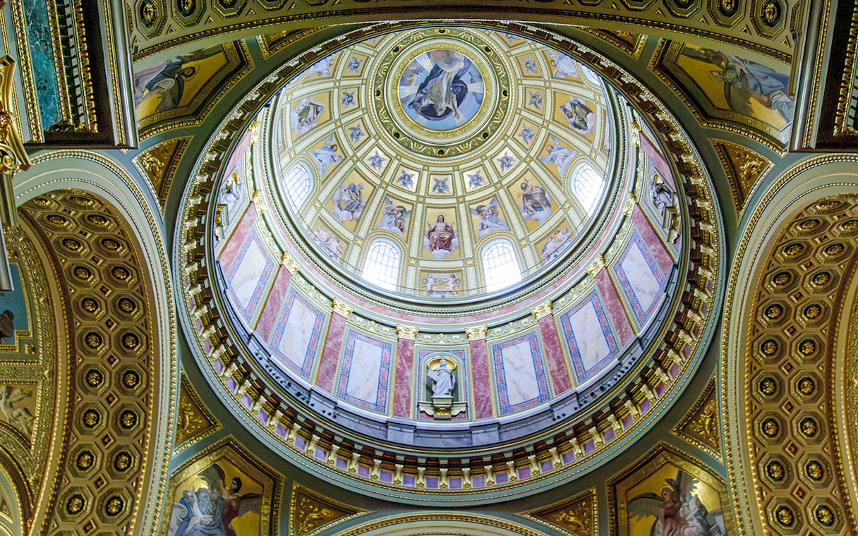 Interior dome of Esztergom Basilica with ornate frescoes and architectural details.