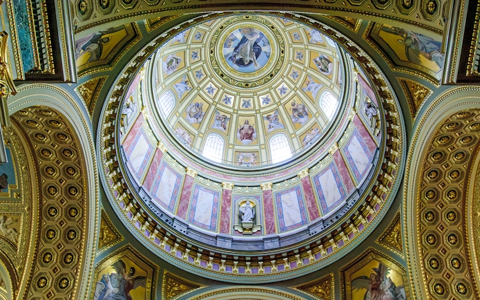 Interior dome of Esztergom Basilica with ornate frescoes and architectural details.
