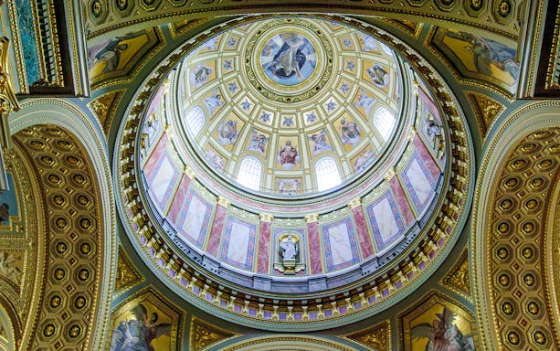 Interior dome of Esztergom Basilica with ornate frescoes and architectural details.