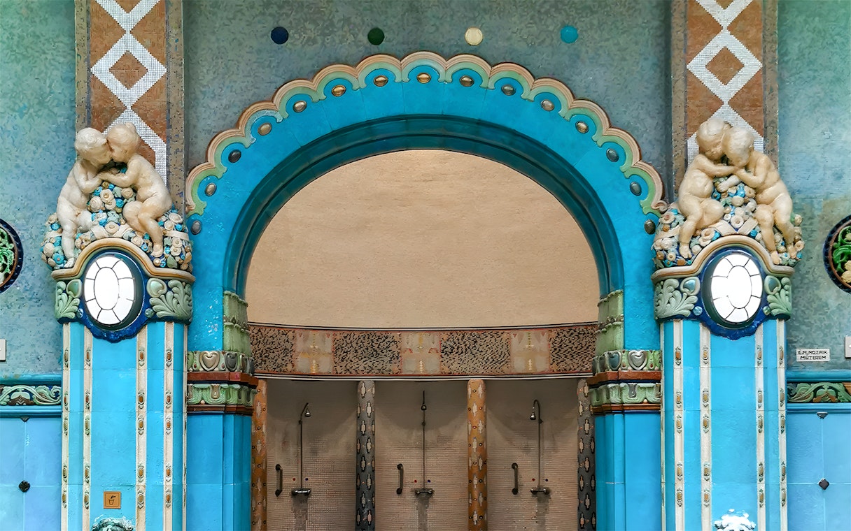 Mosaic blue tiles and ornate archway in Gellert Thermal Bath, Budapest.