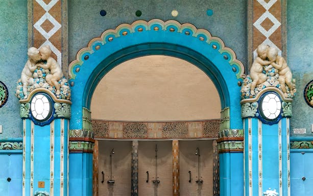 Mosaic blue tiles and ornate archway in Gellert Thermal Bath, Budapest.
