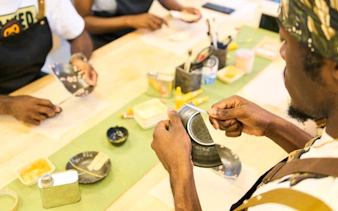 Participants repairing pottery at a Kintsugi workshop in Shinjuku, Tokyo.