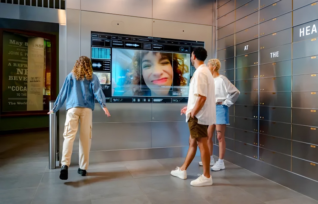 Visitors interacting with a digital display at The Vault, World of Coca-Cola, Atlanta.