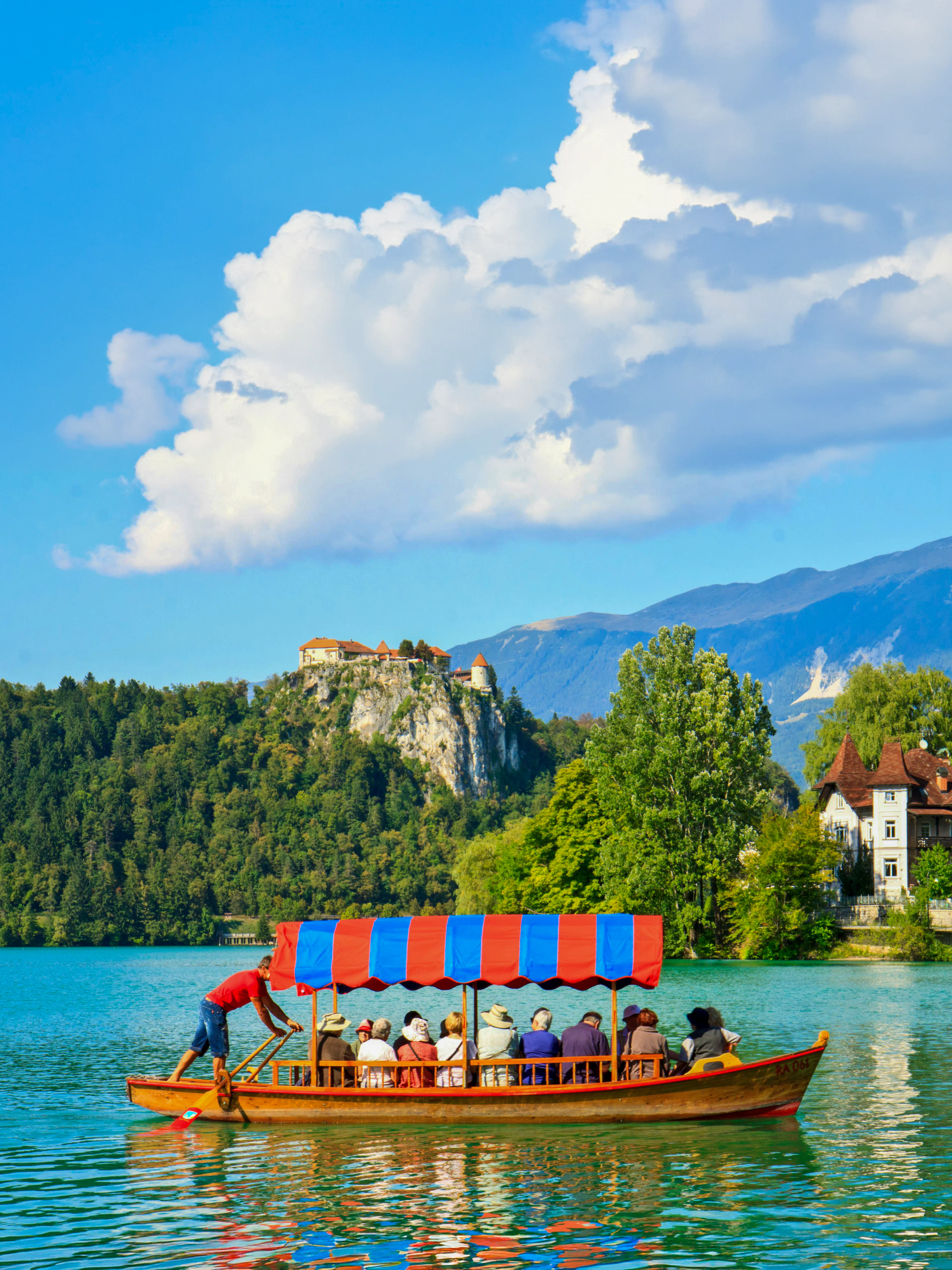 Boat on Lake Bled with Bled Castle in the background, Slovenia.