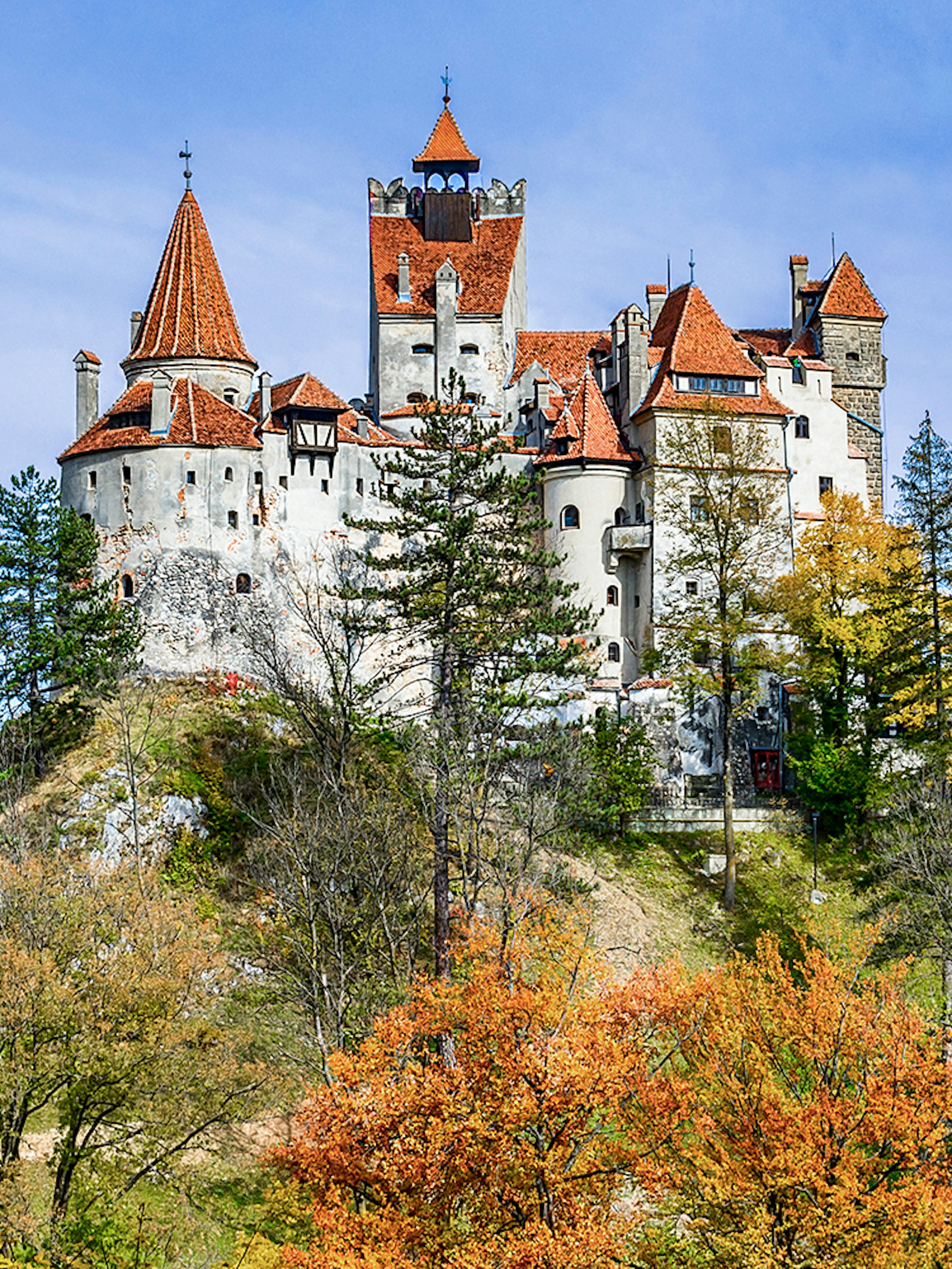 Bran Castle surrounded by autumn trees, Romania.