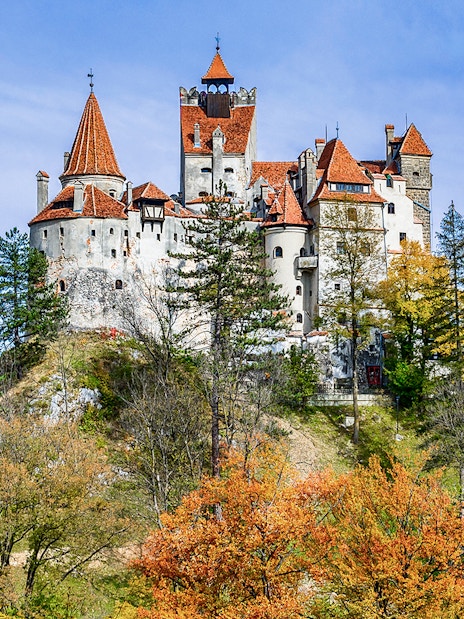 Bran Castle surrounded by autumn trees, Romania.