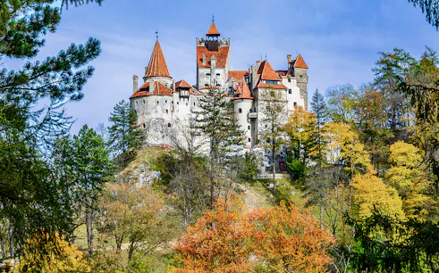 Bran Castle surrounded by autumn trees, Romania.