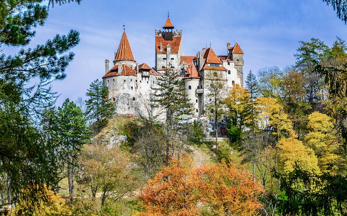 Bran Castle surrounded by autumn trees, Romania.