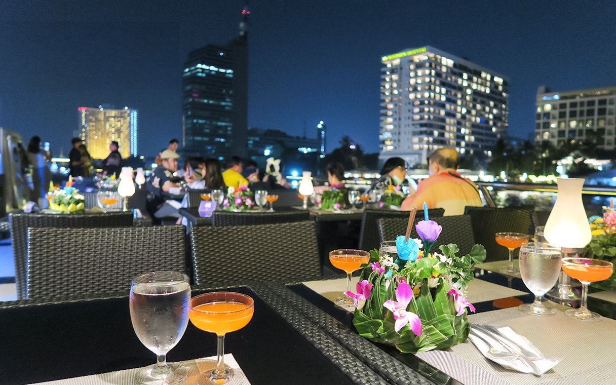 Dining setup on Royal Princess Cruise with city skyline at night.