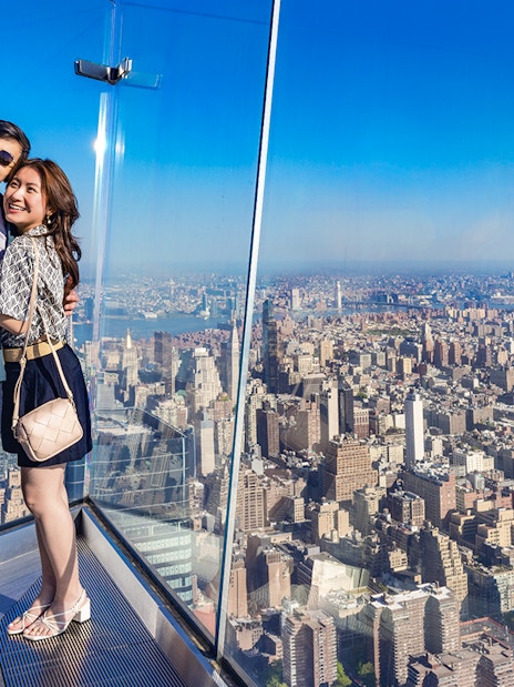 Couple taking a selfie at Edge Observation Deck with New York City skyline.