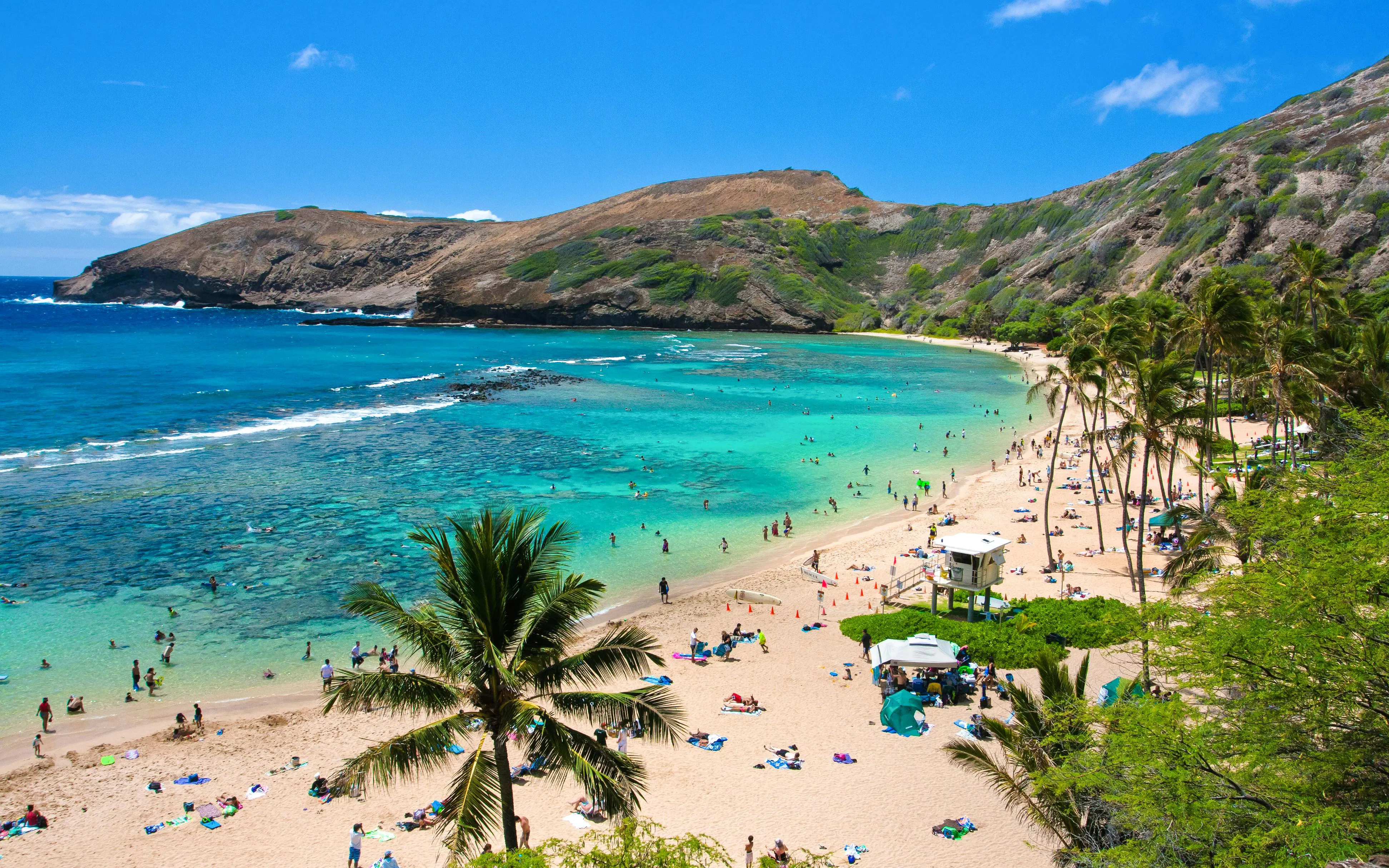 Visitors enjoying the beach and snorkeling in Hanauma Bay, Oahu, Hawaii.