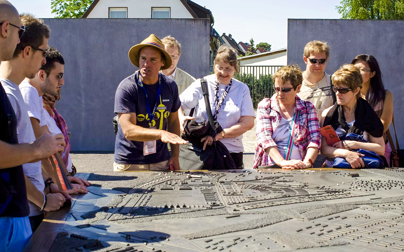 Visitors at Sachsenhausen Concentration Camp Memorial with guide, exploring historical site in Oranienburg, Germany.