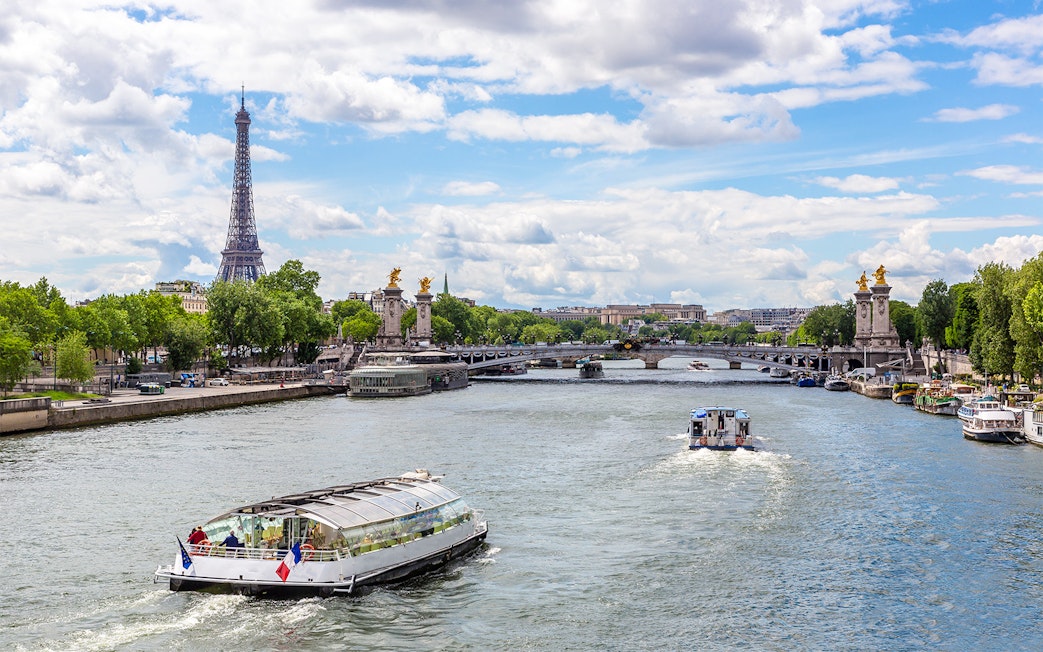 Seine River cruise with Eiffel Tower and Pont Alexandre III in Paris.
