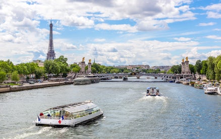 Seine River cruise with Eiffel Tower and Pont Alexandre III in Paris.
