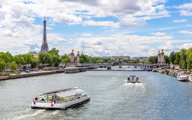 Seine River cruise with Eiffel Tower and Pont Alexandre III in Paris.