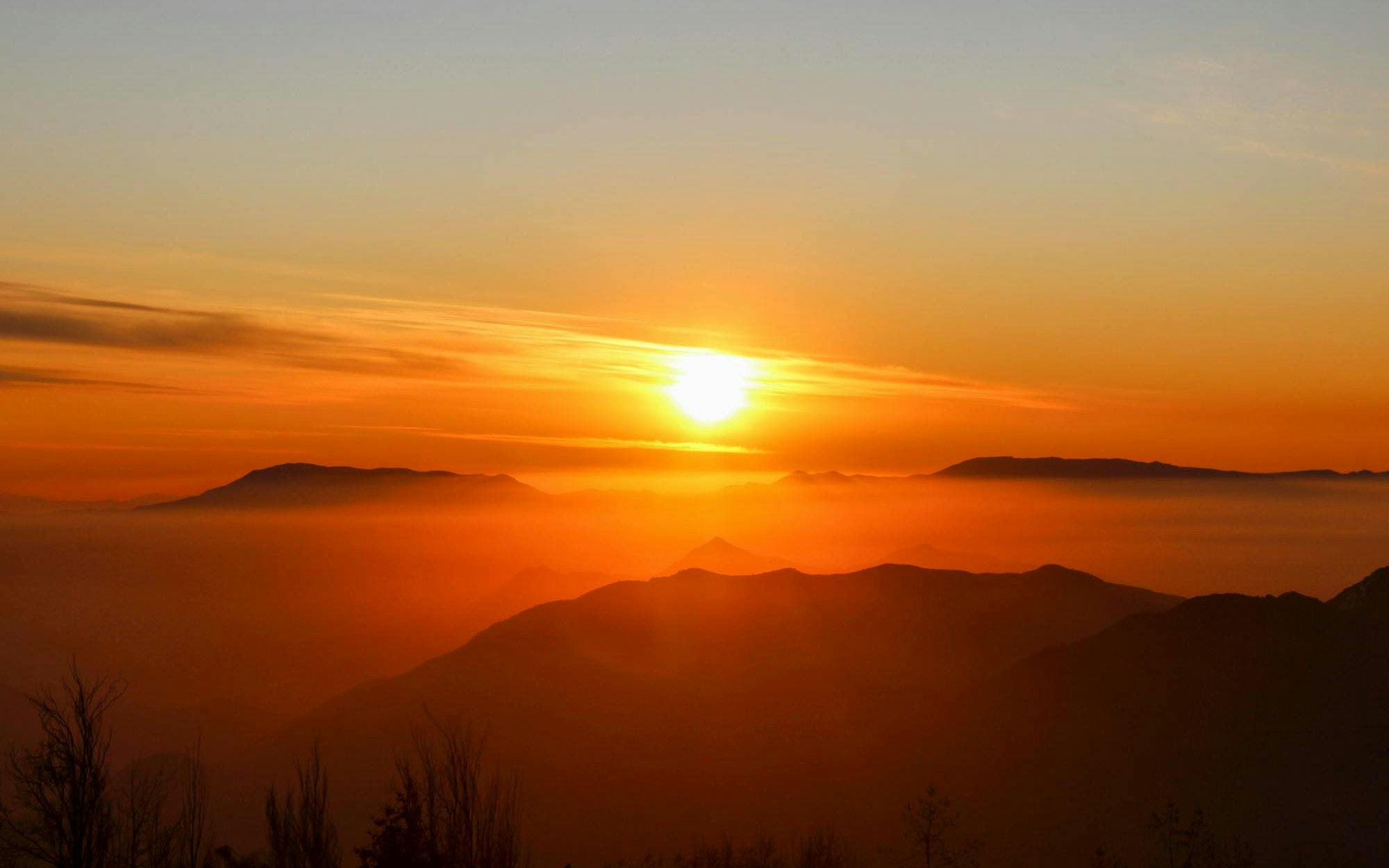 Sunset over Andes Mountains in Chile with silhouetted peaks.