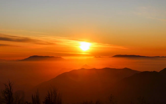 Sunset over Andes Mountains in Chile with silhouetted peaks.