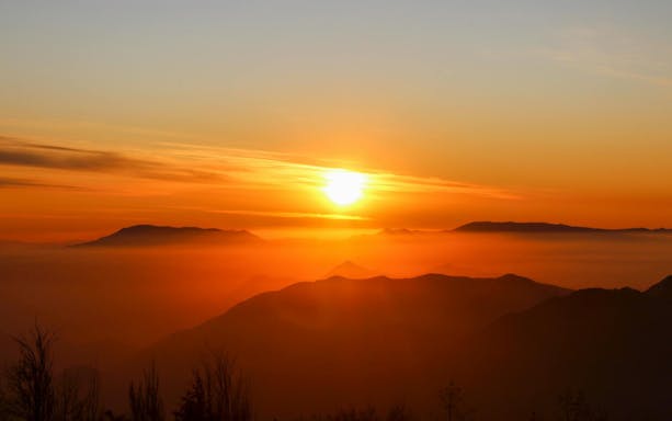 Sunset over Andes Mountains in Chile with silhouetted peaks.