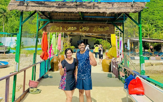 Couple smiling at Robinson Beach entrance, Nha Trang island-hopping adventure.