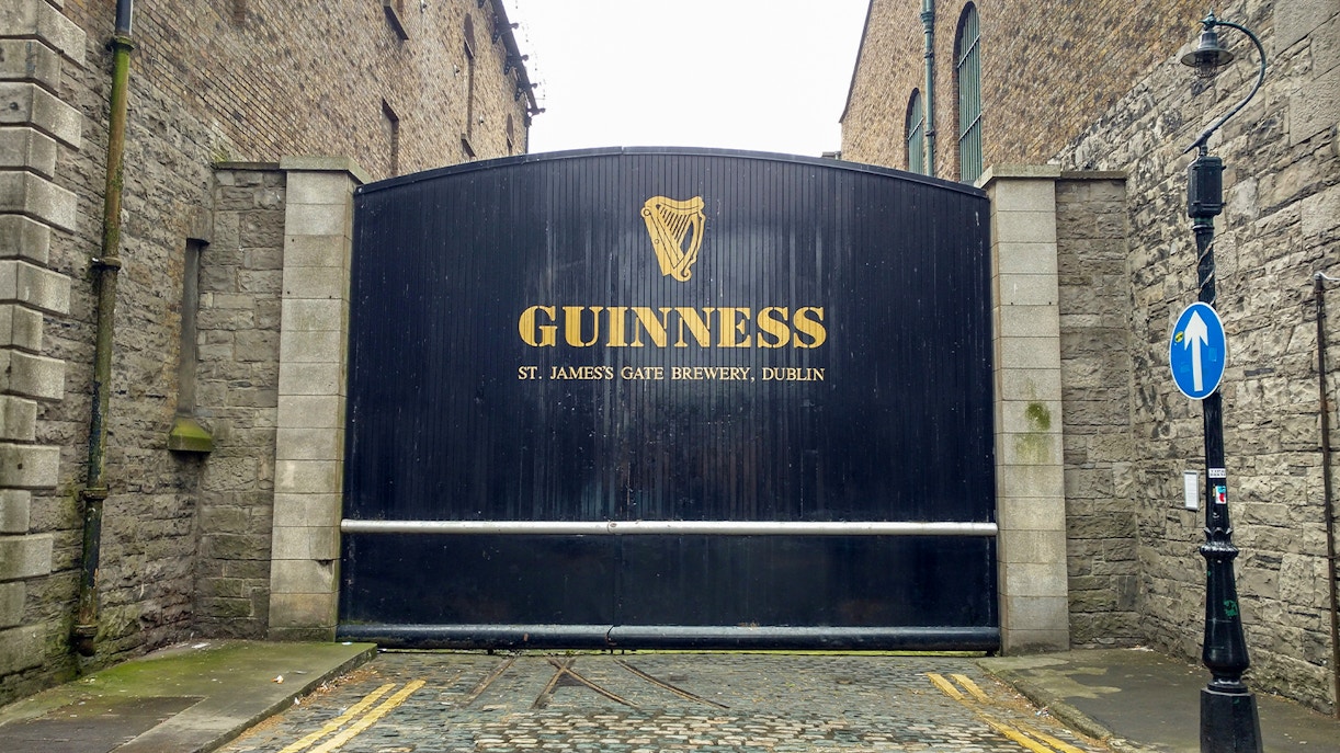 Hop-on hop-off bus in Dublin with view of Guinness Storehouse and Gravity Bar.