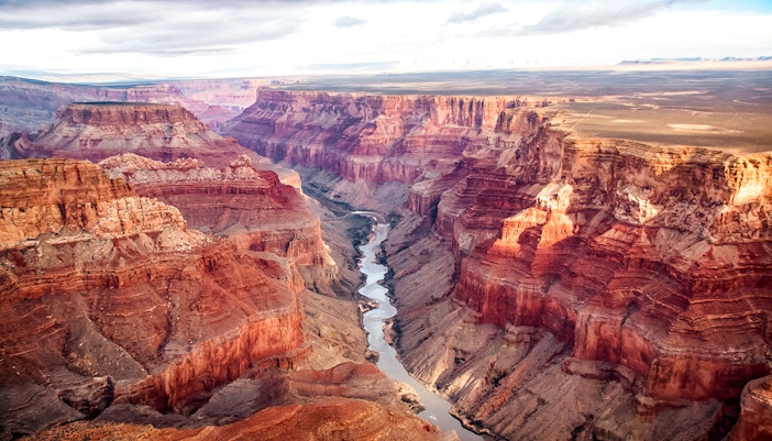Aerial view of the Grand Canyon's south and north rims with river below.
