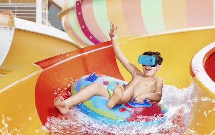 Child enjoying a water slide at Aquapalace Water World.