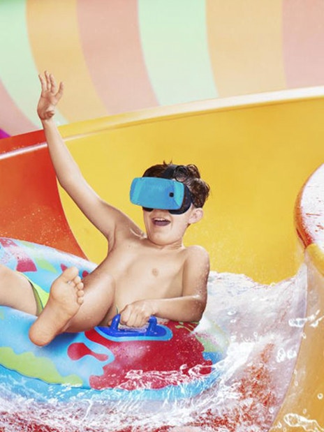 Child enjoying a water slide at Aquapalace Water World.