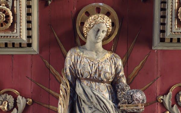 Statue of Saint Agnes holding a lamb in the Catacombs of Saint Agnes, Rome.