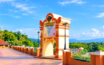 Ornate archway with map detail at scenic viewpoint, Chiang Rai, Thailand.