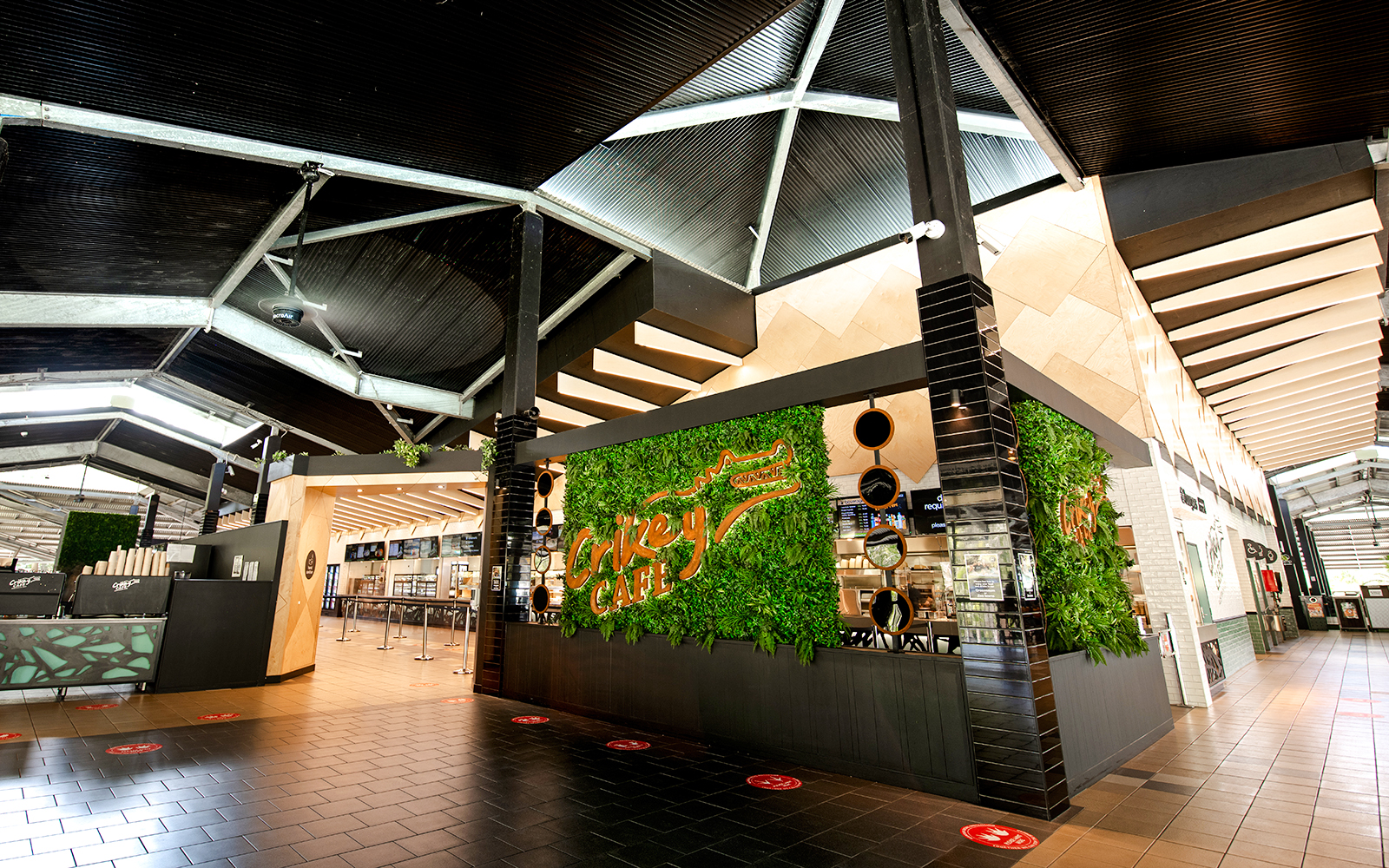 Crikey Cafe entrance at Australia Zoo with green wall decor.