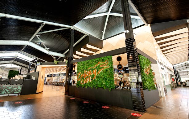 Crikey Cafe entrance at Australia Zoo with green wall decor.