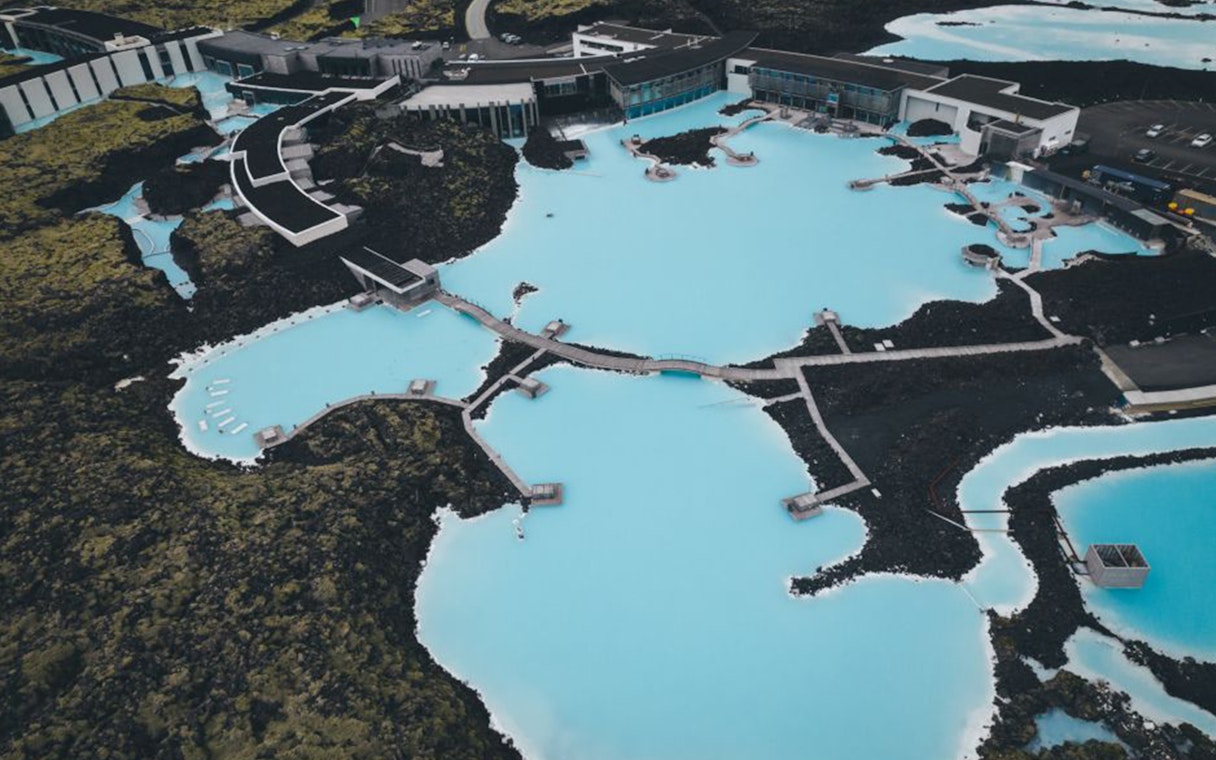 Aerial view of Blue Lagoon geothermal spa near Reykjavík, surrounded by volcanic landscape.