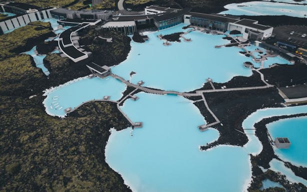 Aerial view of Blue Lagoon geothermal spa near Reykjavík, surrounded by volcanic landscape.