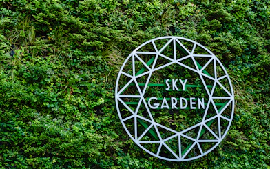 Sky Garden sign on green wall at 20 Fenchurch Street, London.