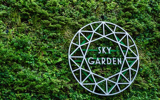 Sky Garden sign on green wall at 20 Fenchurch Street, London.