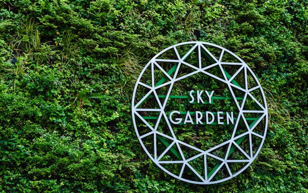 Sky Garden sign on green wall at 20 Fenchurch Street, London.