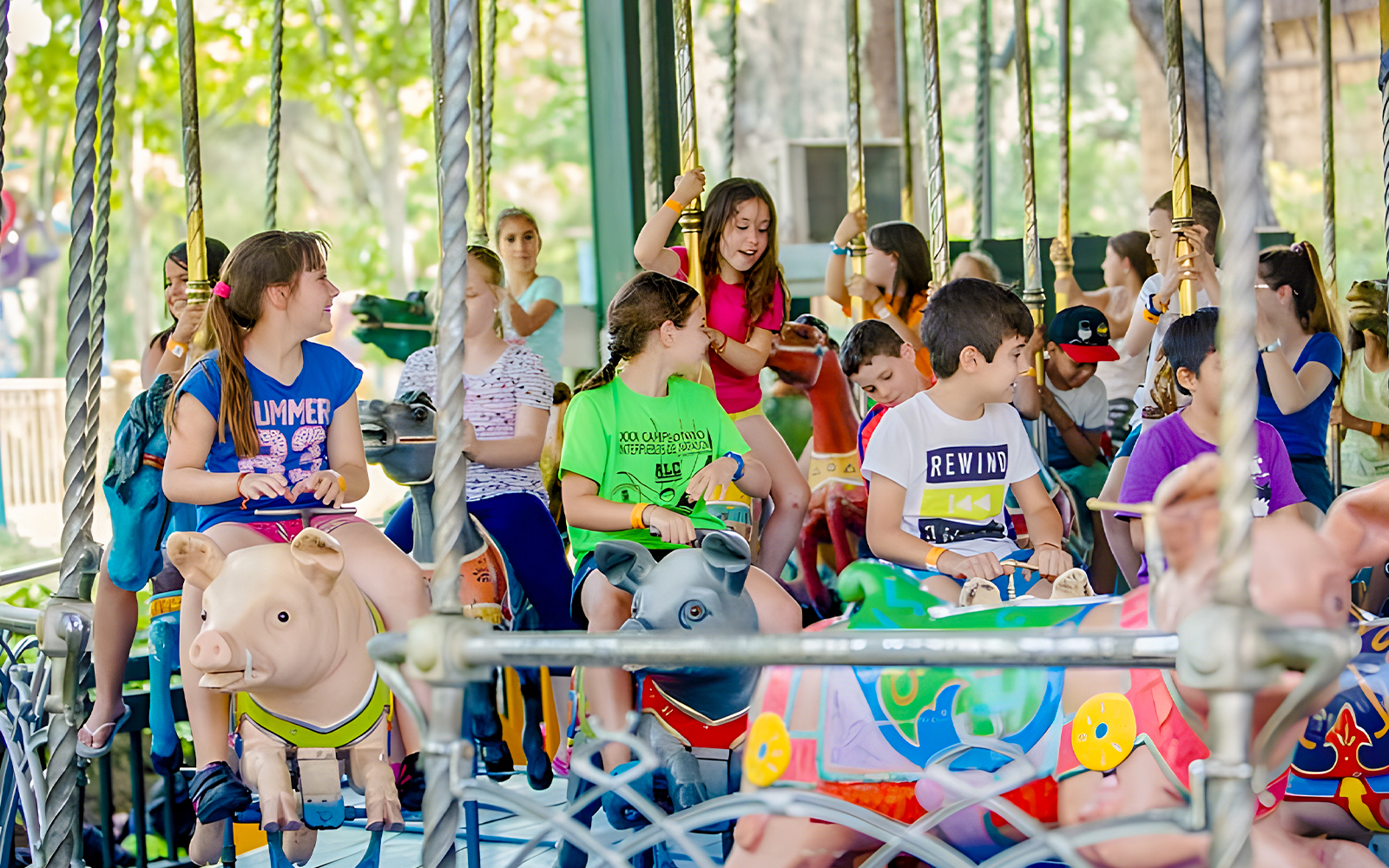 Children enjoying a carousel ride at Parque de Atracciones de Madrid.